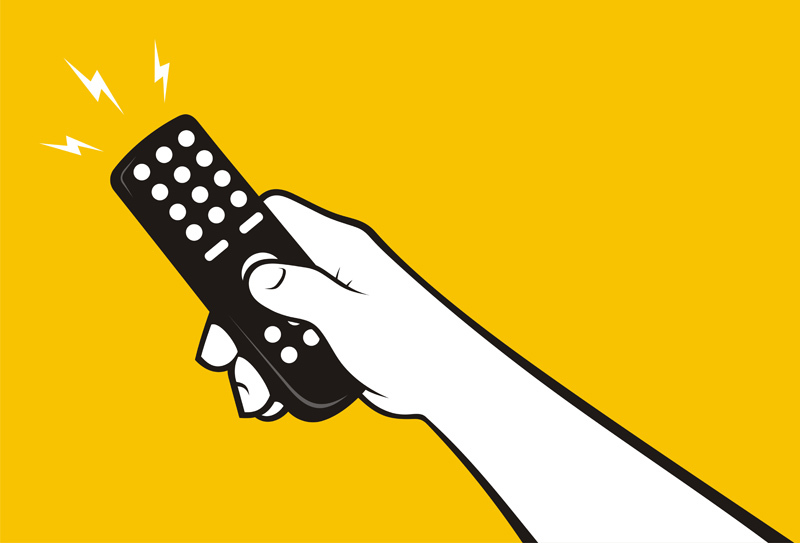 Hand using a remote on a yellow background