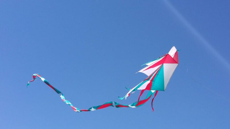 Kite flying freely against a blue sky.