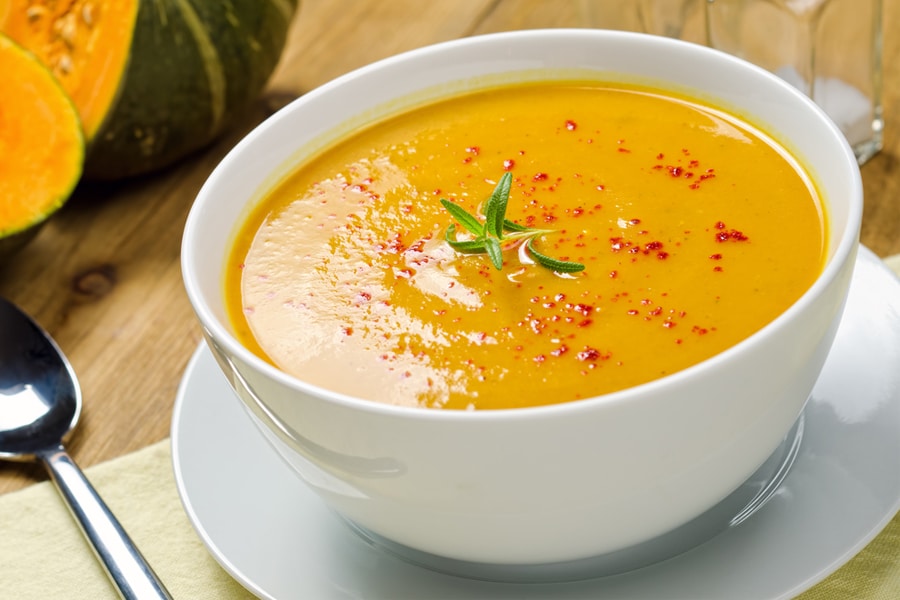 yellow and orange soup in a bowl