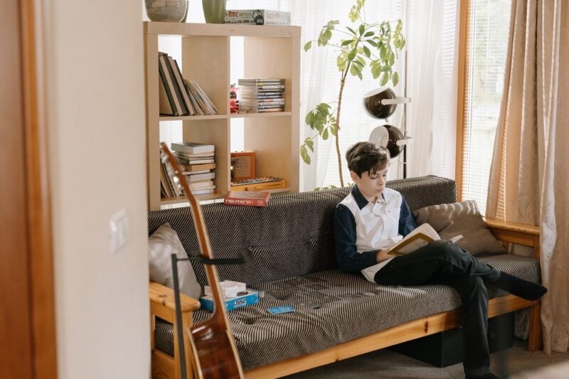 boy-sitting-on-a-couch-reading