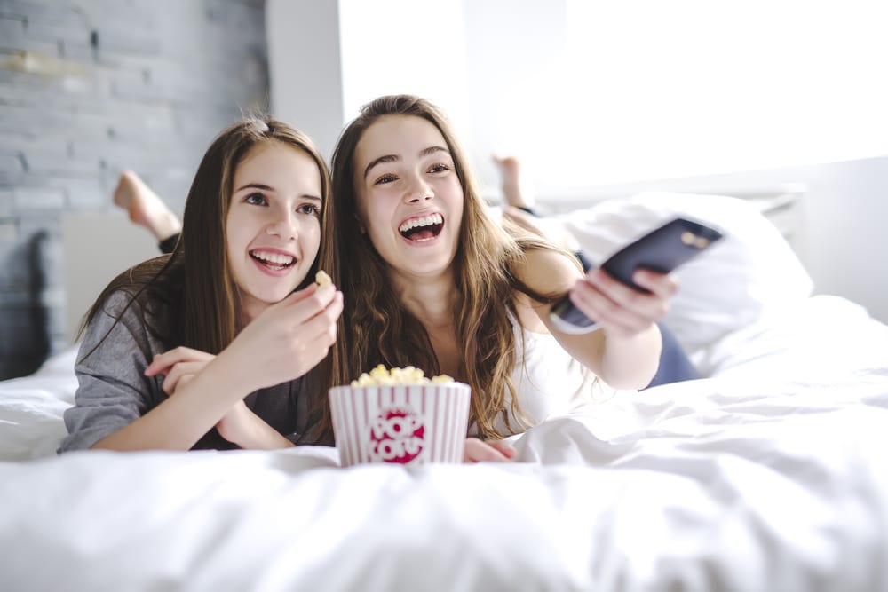 two-girls-watching-movie-at-home