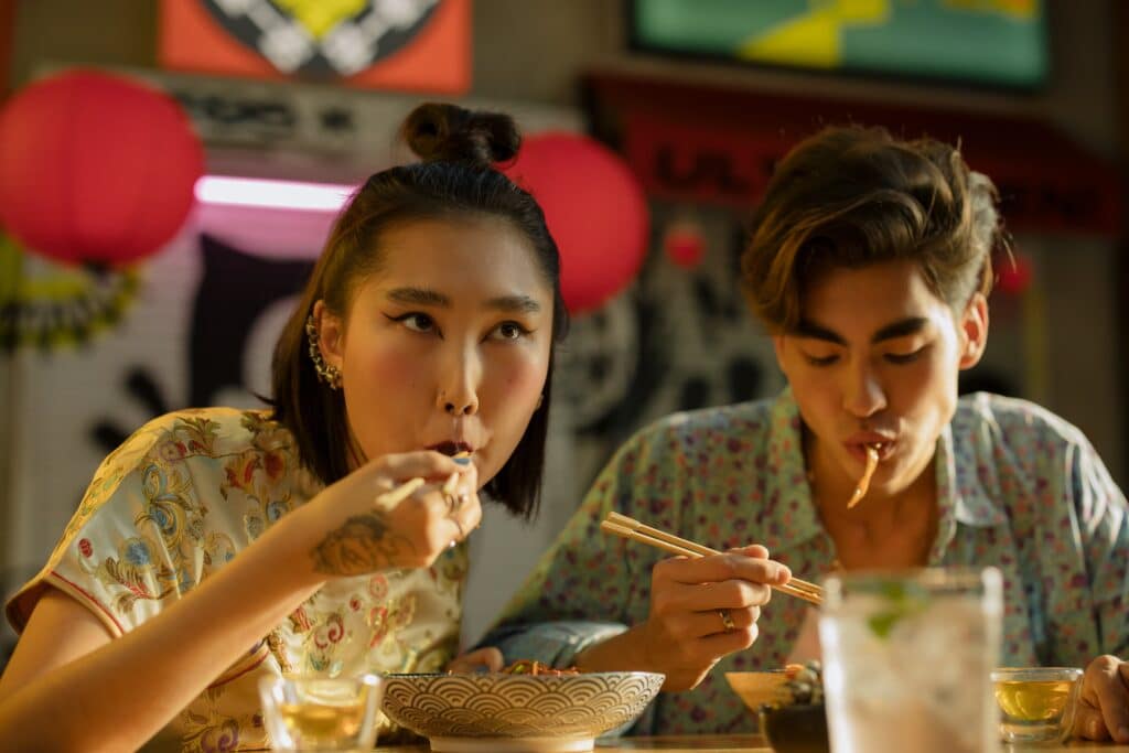 Two people eating noodles in a Chinese restaurant