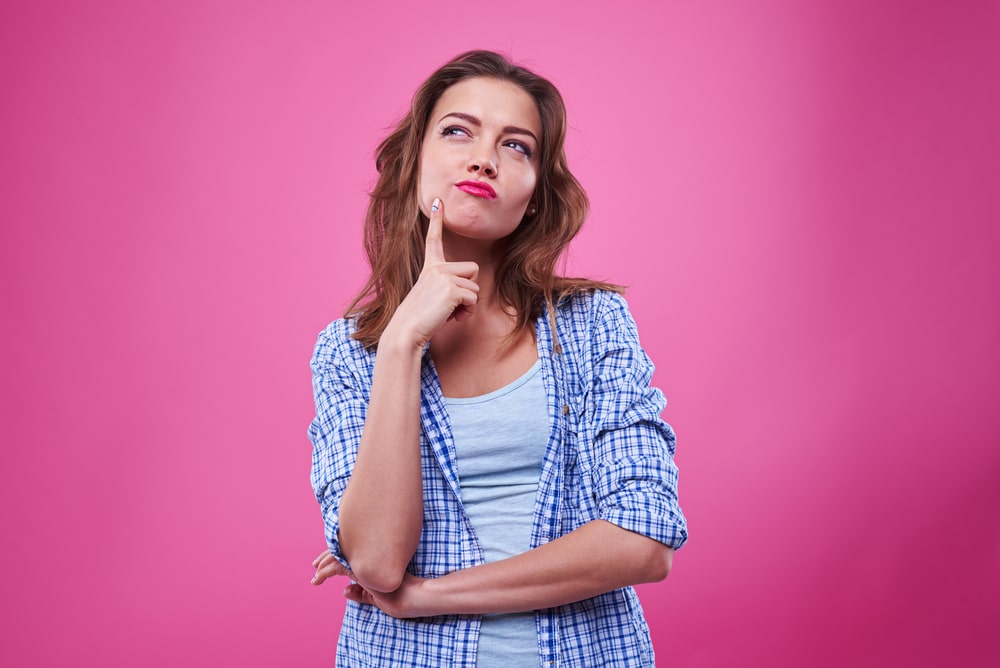 Woman Thinking With Hot Pink Background