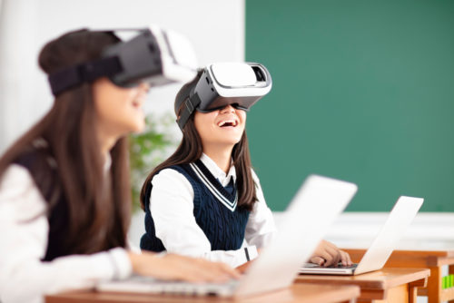 Two students with VR headsets on