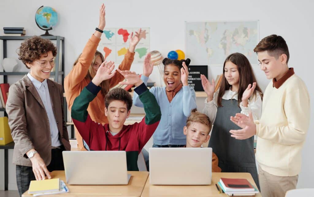 teacher-and-students-in-front-of-computers-having-fun