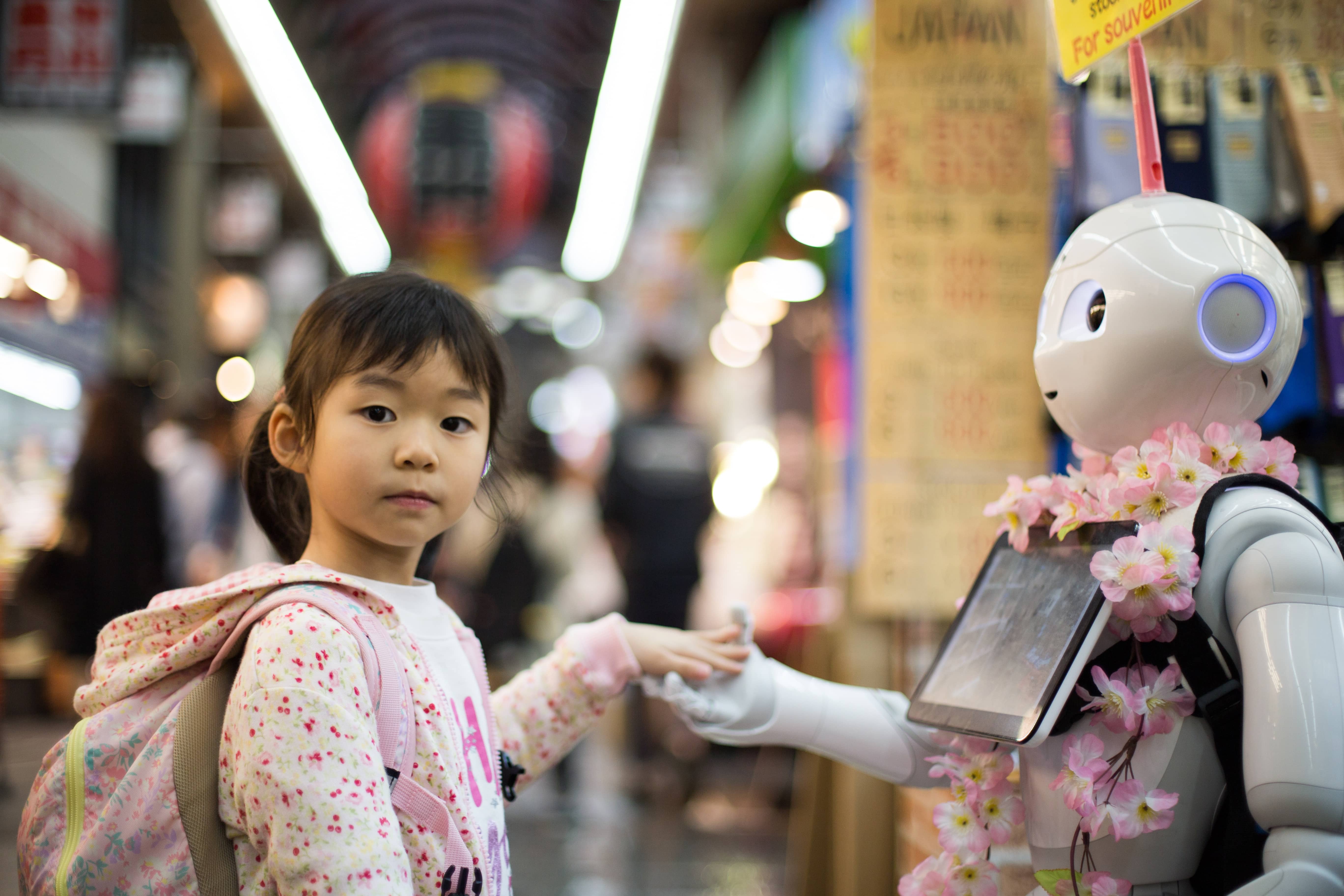 A girl interacts with a robot