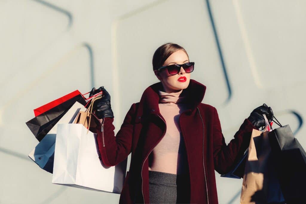 A chic woman shopping and holding shopping bags