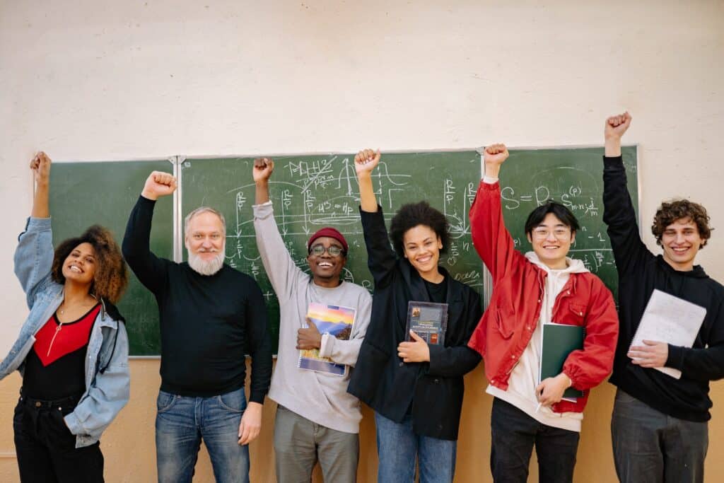 six-multiethnic-individuals-raising-their-hands-in-a-happy-fist-bump