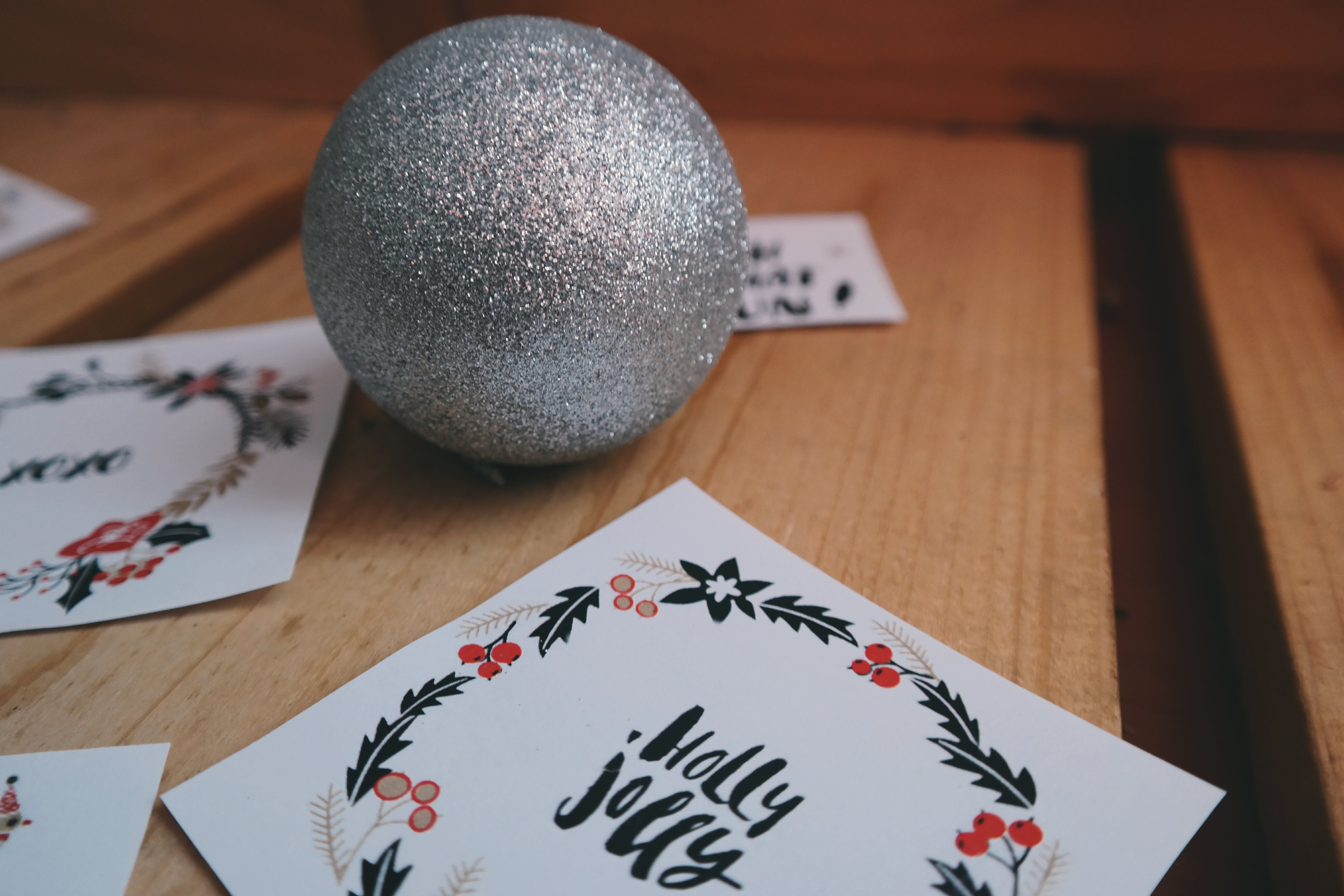 Holiday cards on a table with an ornament