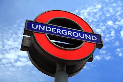 London Underground sign in front of blue sky