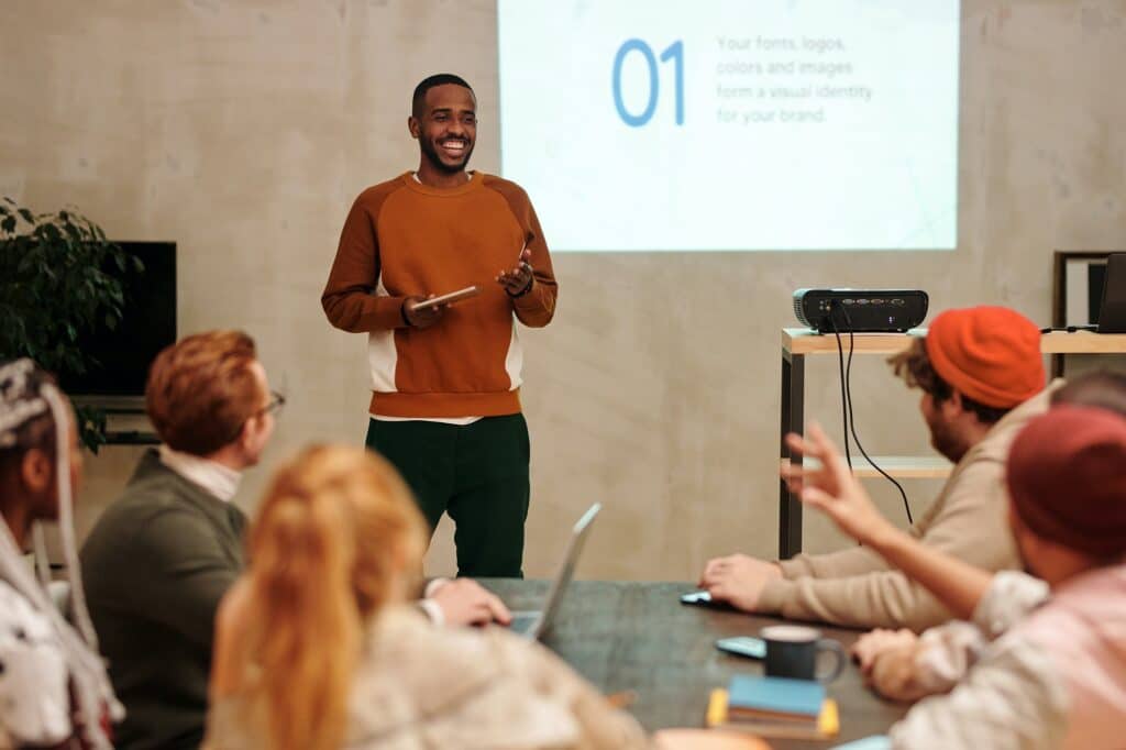 man-giving-powerpoint-presentation-to-a-group-of-people
