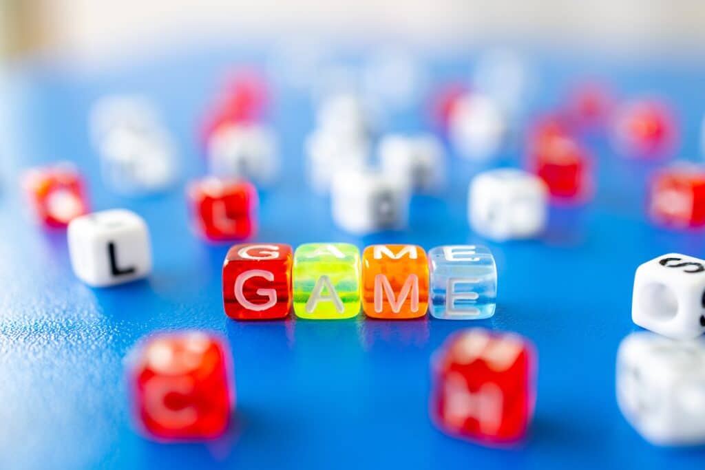 Game dice spelling out the word "game"