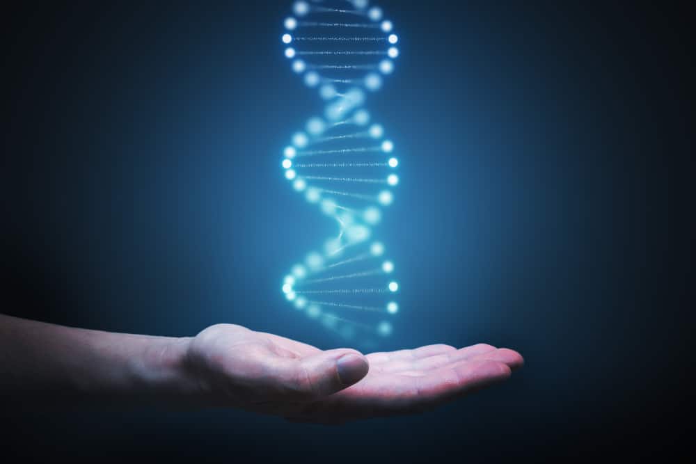 hand holding glowing DNA molecule