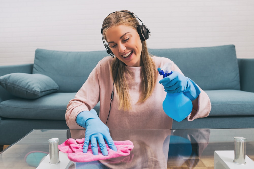 Woman cleaning while listening to music