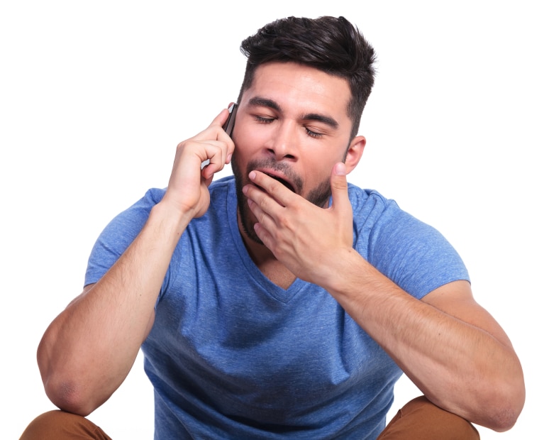 seated casual man is being bored by the phone conversation