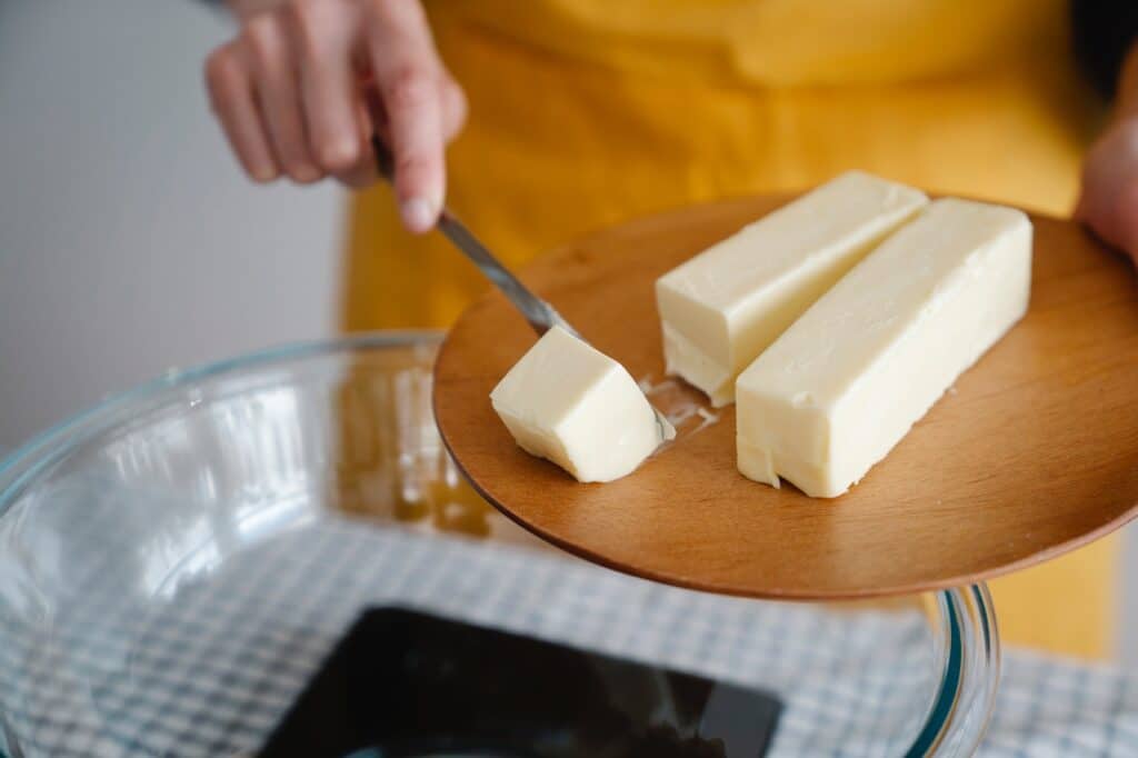 A person cutting butter.