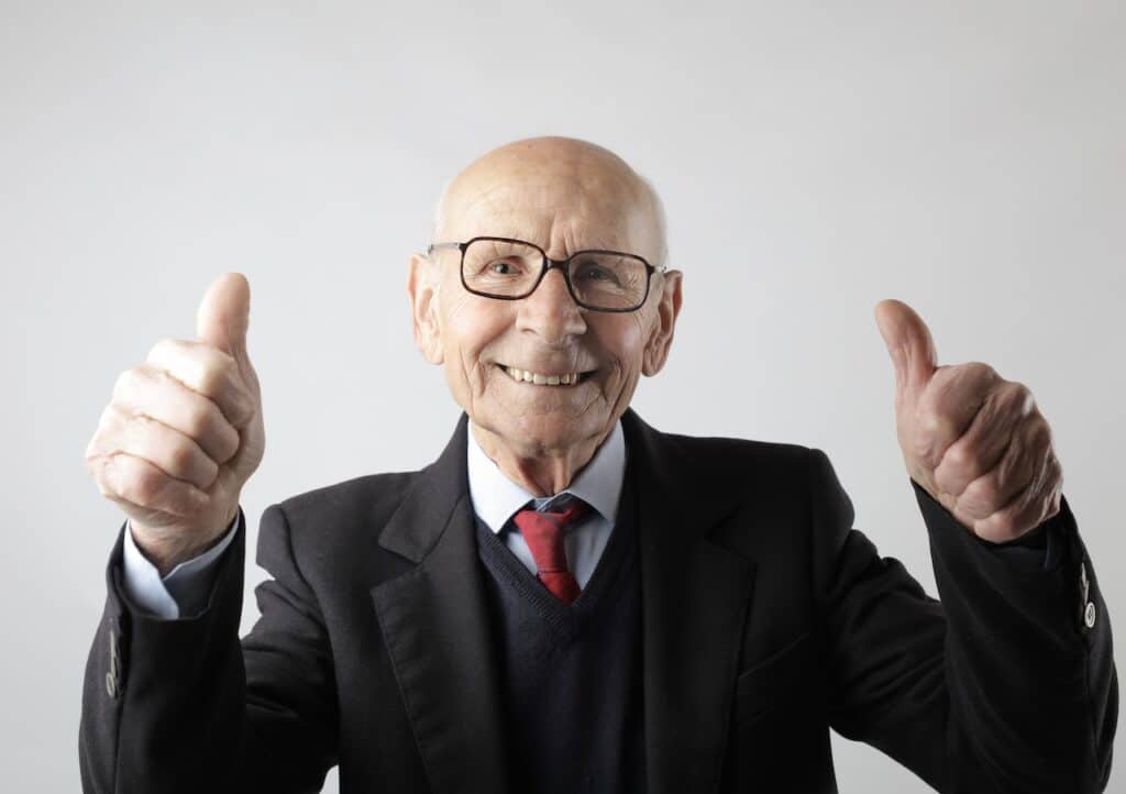 old man smiling with thumbs up