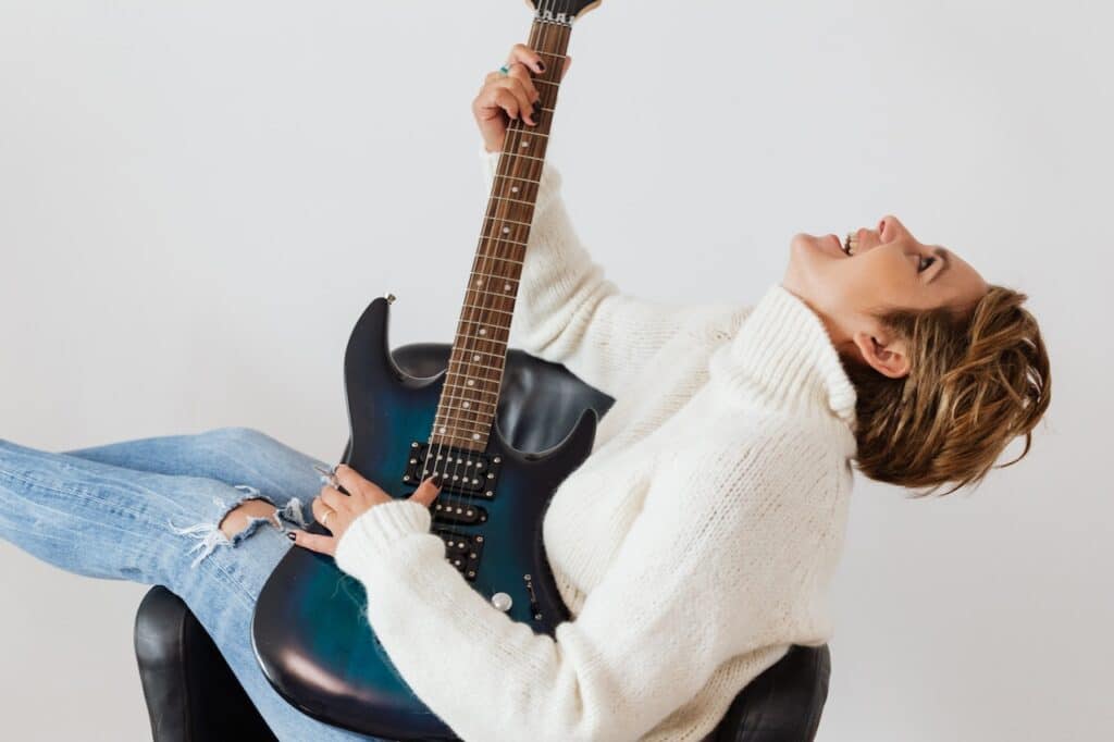 A woman playing guitar