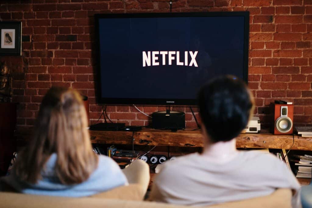 Two people watching Netflix on TV