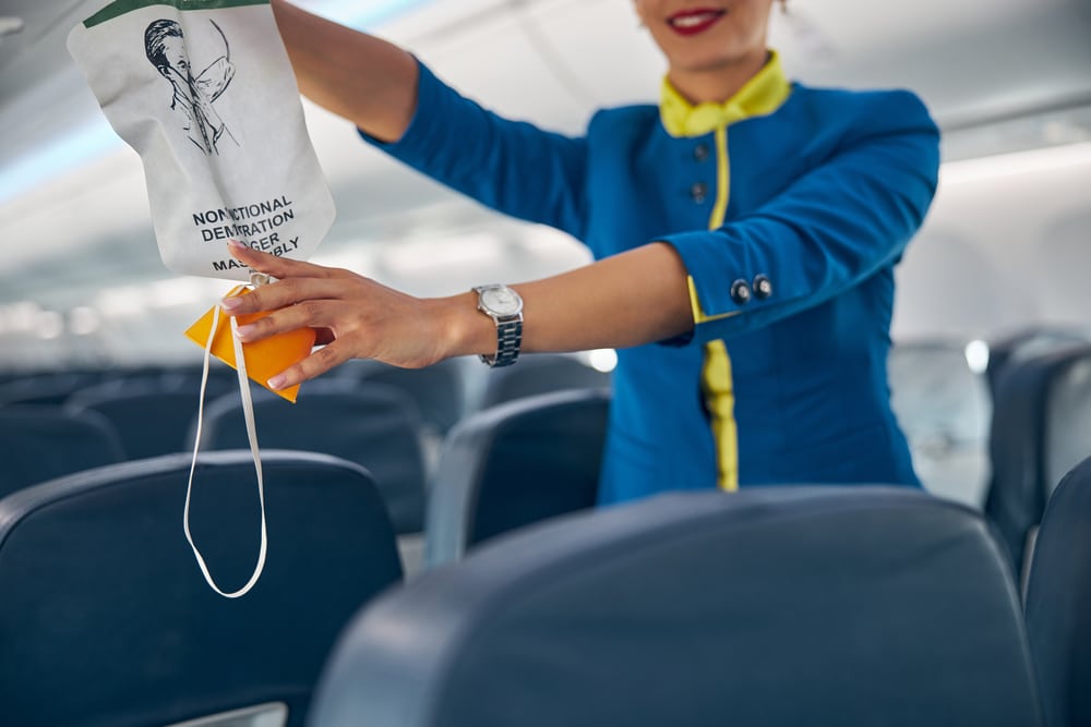 Flight attendant giving safety instructions