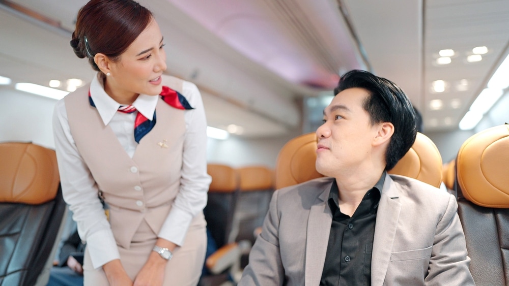Flight captain, stewardess talking with passengers