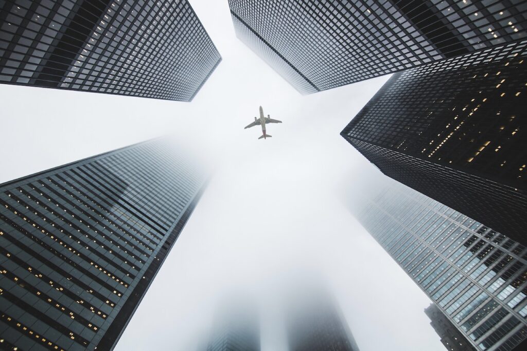 airplane between skyscrapers