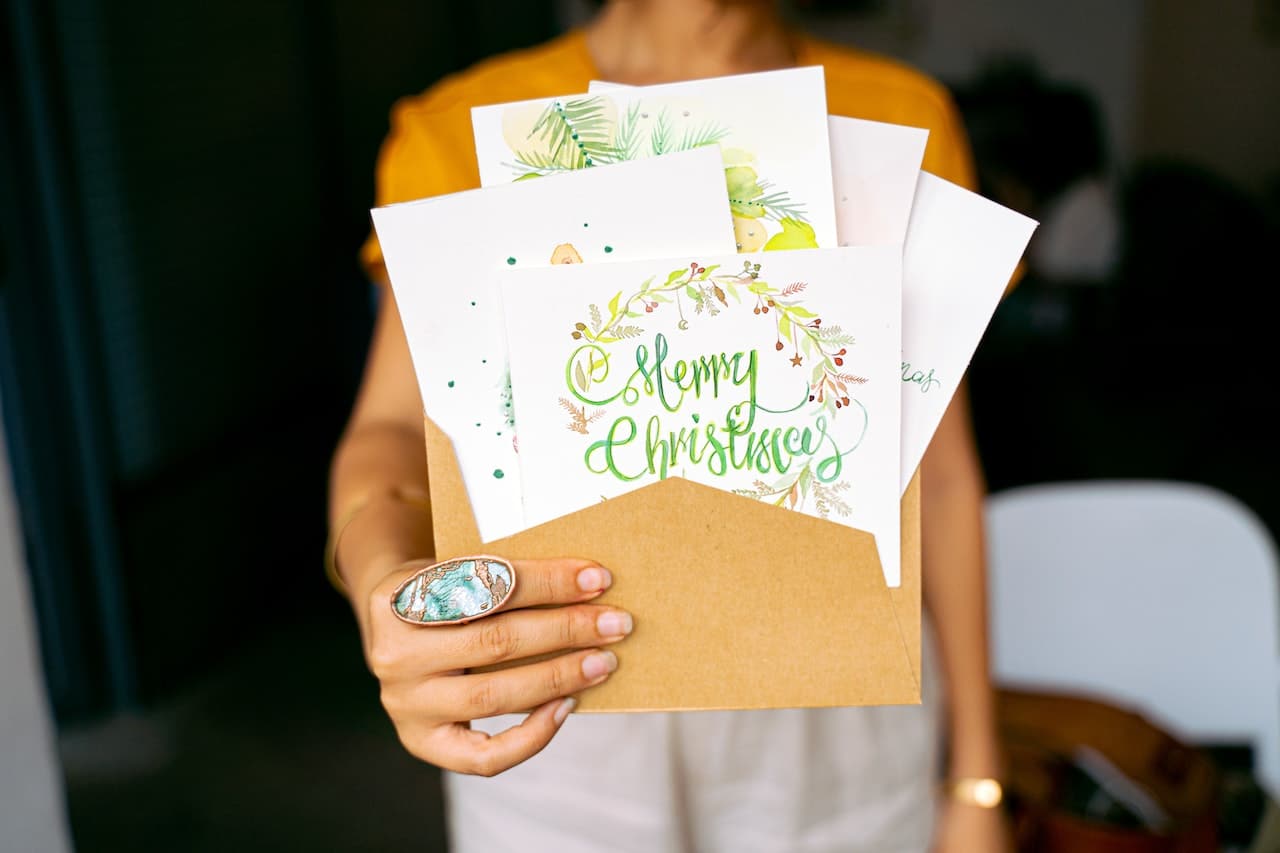 Girl holding several christmas cards
