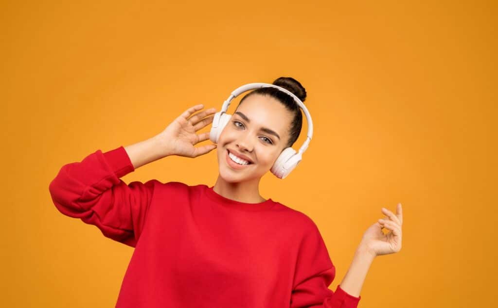 A young woman listening to music with headphones