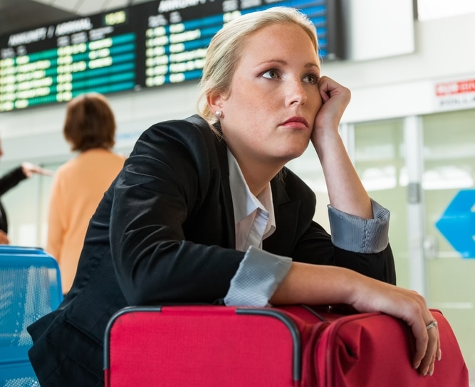 blonde business woman waiting bored at an airport