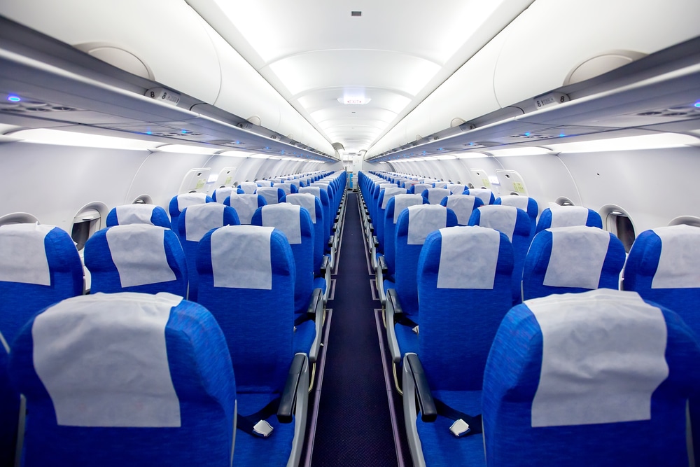 economy class of an airplane with blue seats