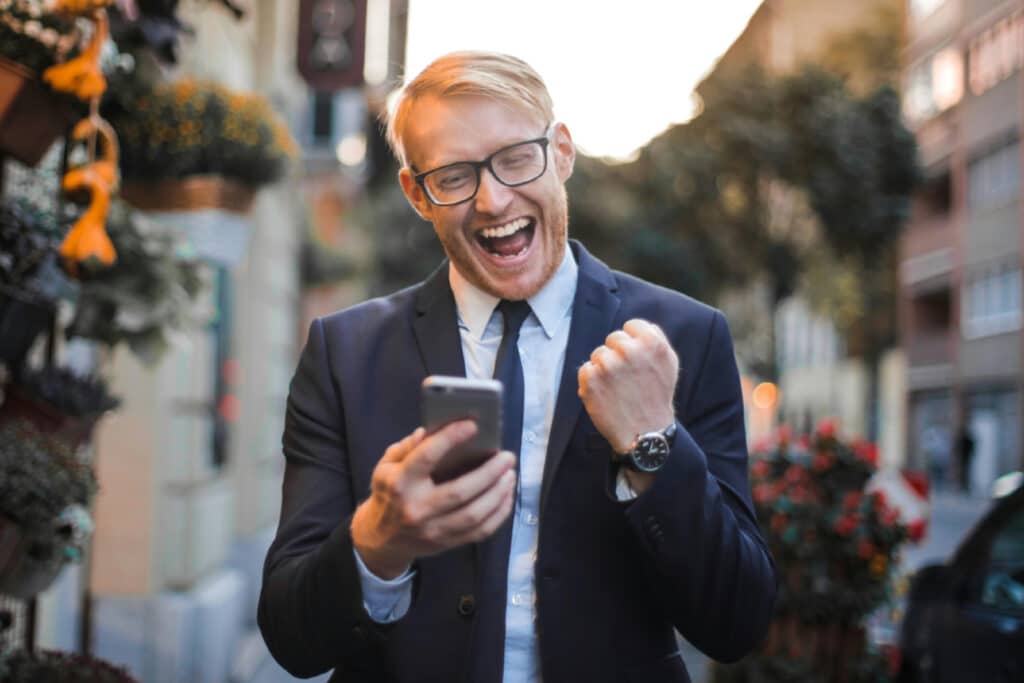 Man in suit holding a phone