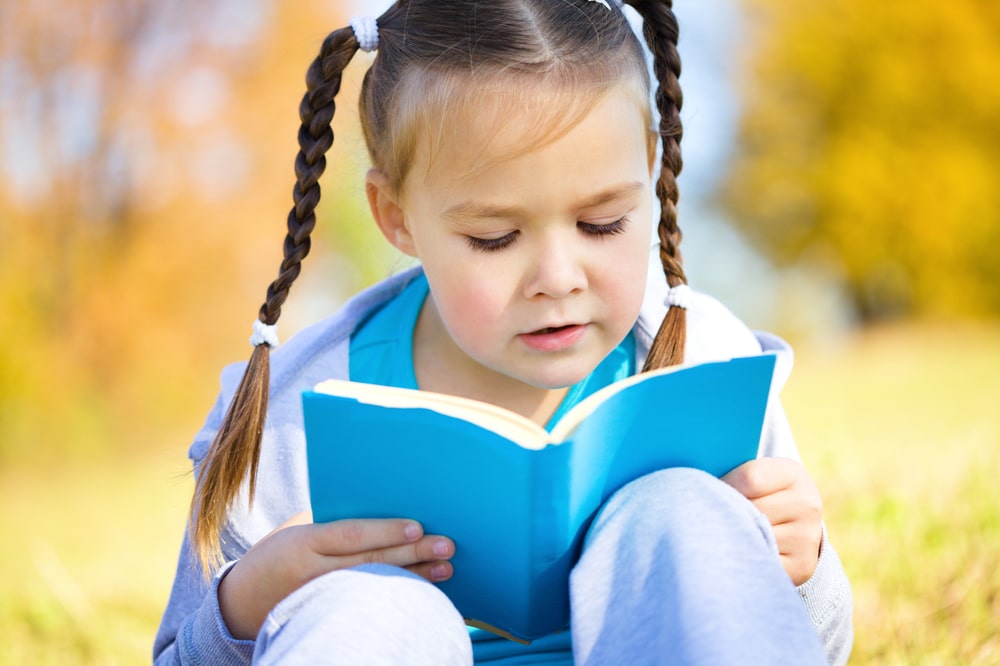 Girl reading a blue book