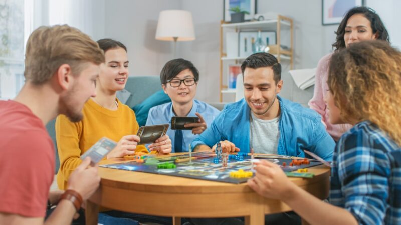 Group-of-people-playing-a-board-game-with-cards-and-dice