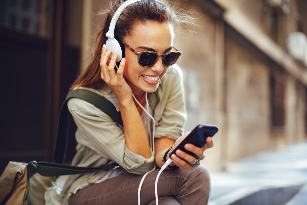 young woman listening to music on phone