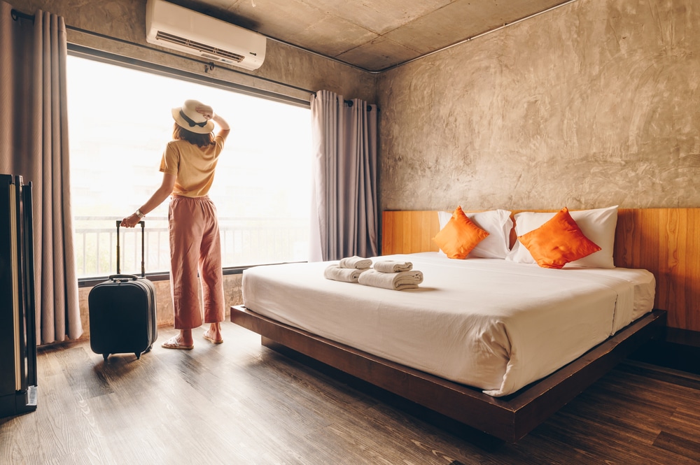 Tourist woman in hotel bedroom
