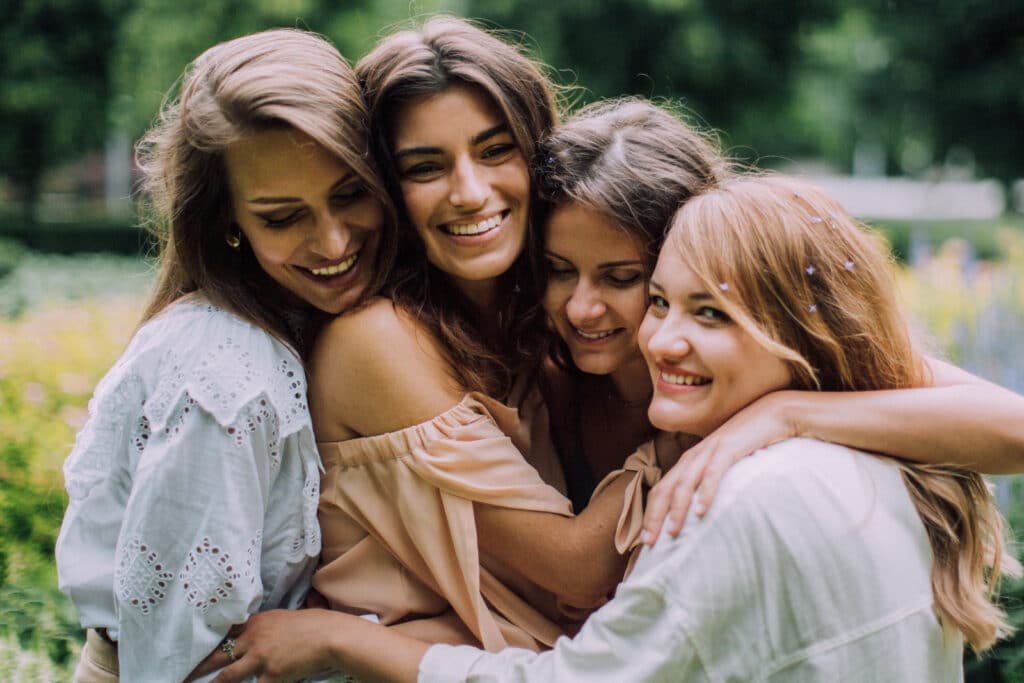 Four women hugging each other