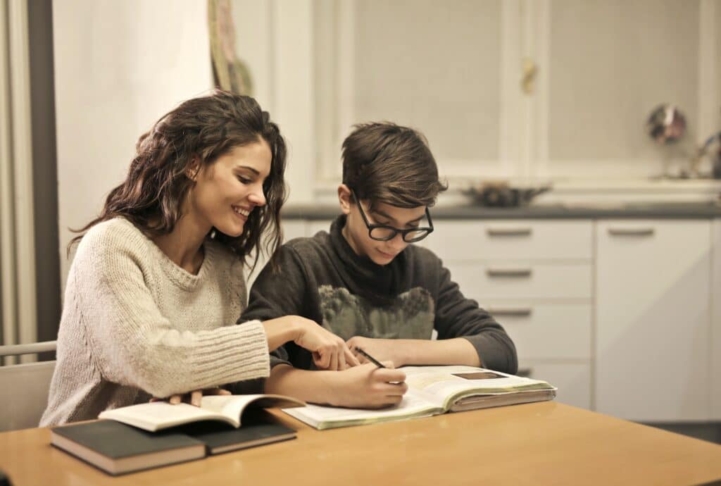 a-photo-of-a-sister-helping-her-brother-study-at-home
