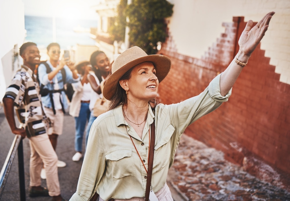 female-tour-guide-with-her-hand-raised-in-the-air-pointing-at-something