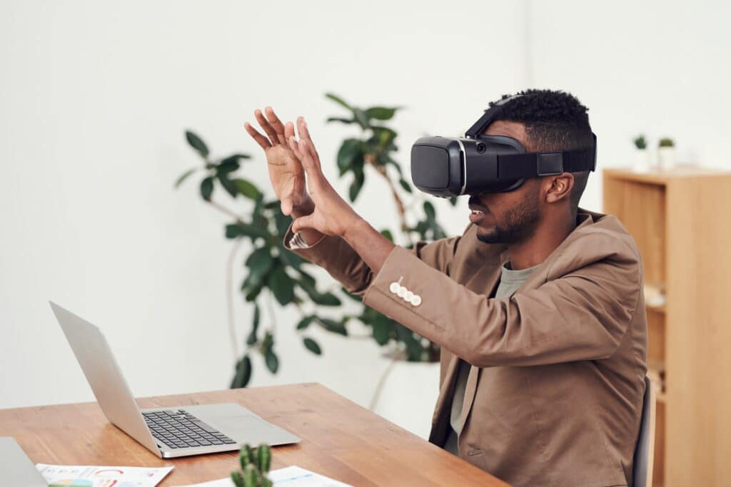 man-of-african-descent-wearing-vr-goggles-and-holding-up-hands-in-front-of-himself