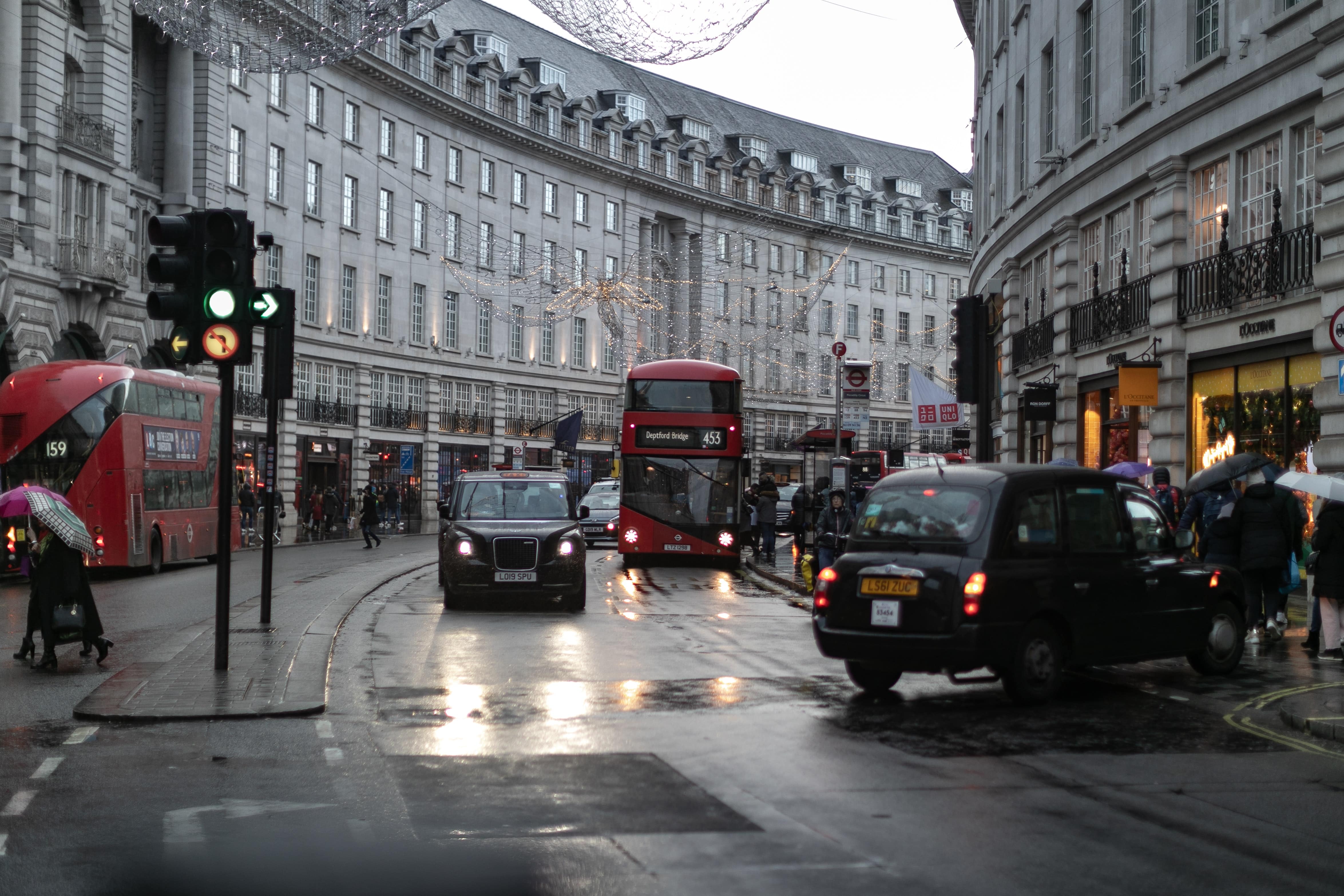 photo-of-buses-and-taxis-on-a-street-in-london-on-a-rainy-day