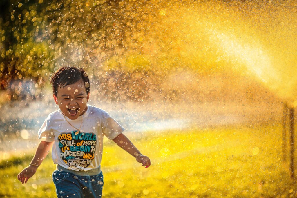 child-running-through-sprinkler