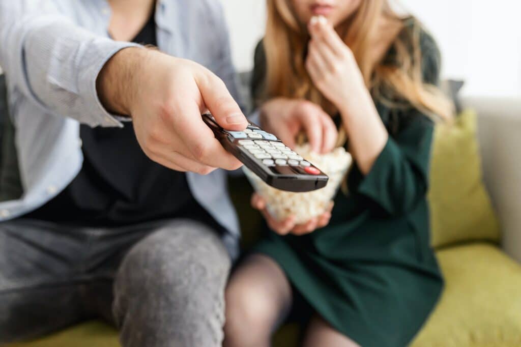 couple-watching-tv-man-holding-remote-control