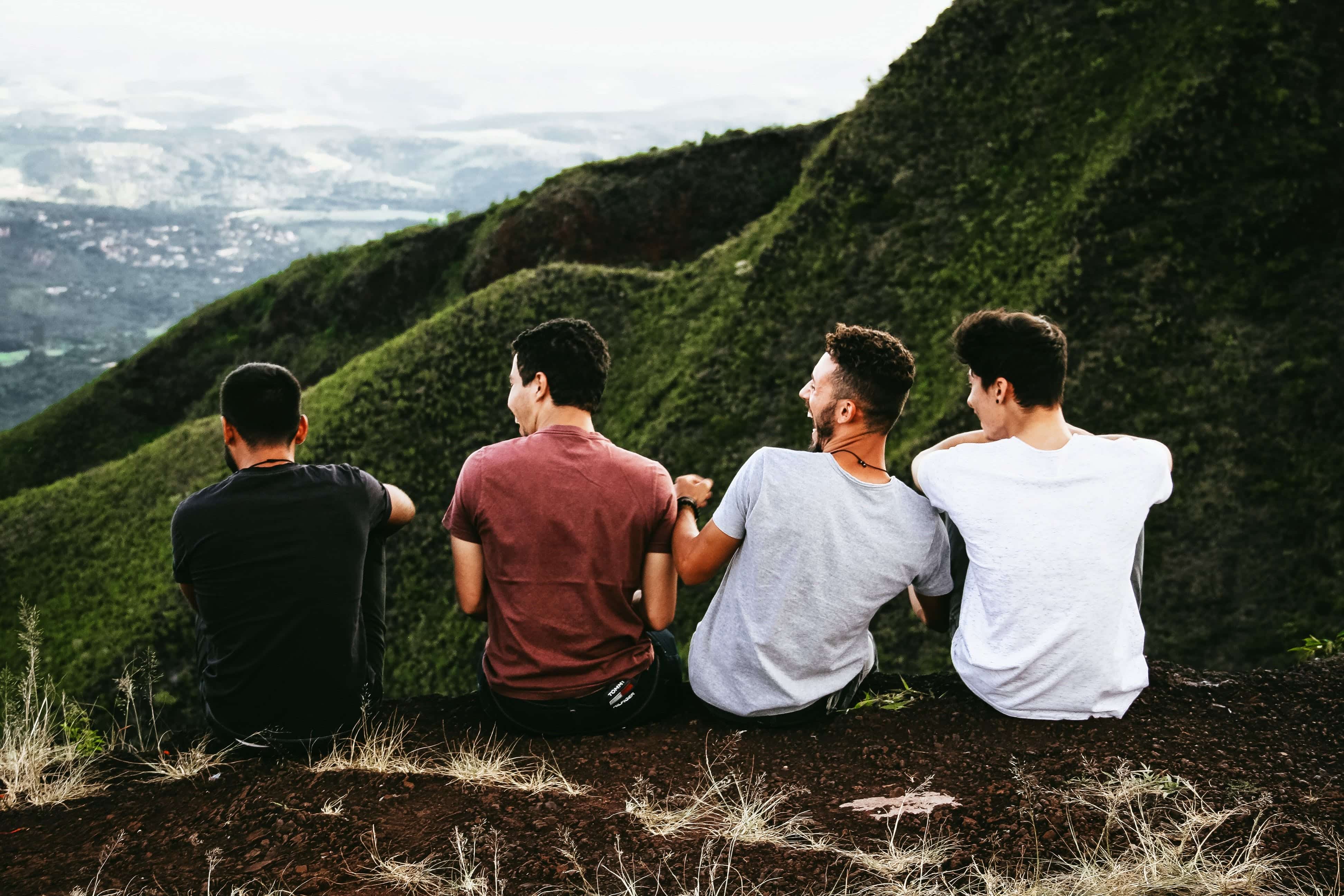 A group of friends laughing and talking at a natural viewpoint