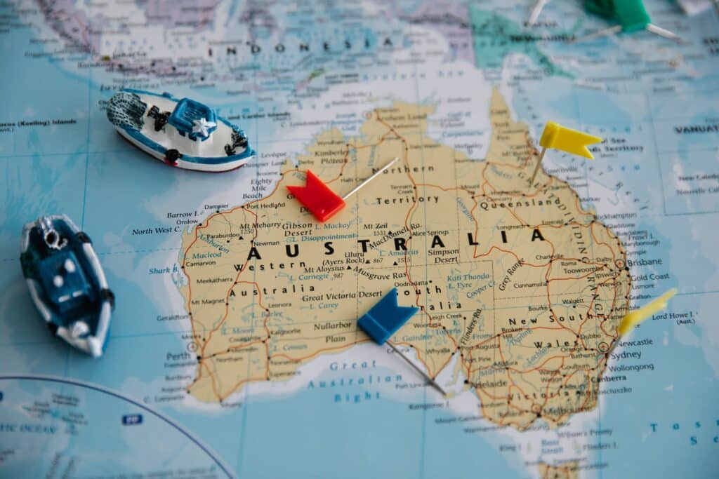 toy-ships-and-toy-flags-on-map-of-australia