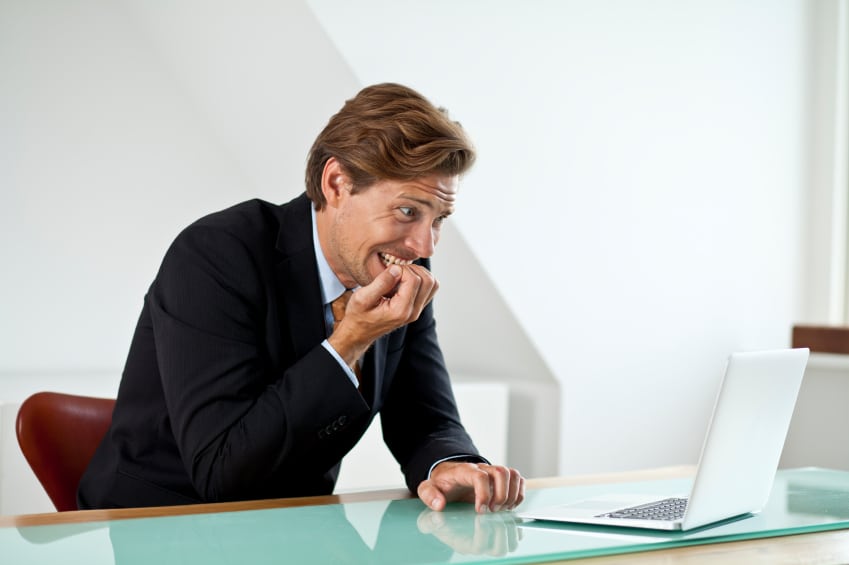 Anxious businessman looking at laptop