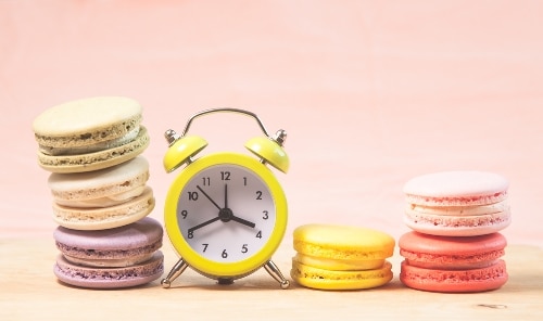 an image of an alarm clock and macaroons of different colors