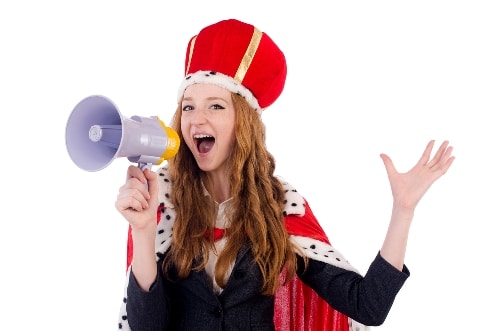 girl wearing a crown and speaking into a megaphone