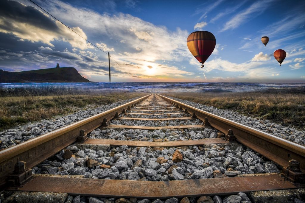 hot-air-balloons-flying-over-a-railway-track