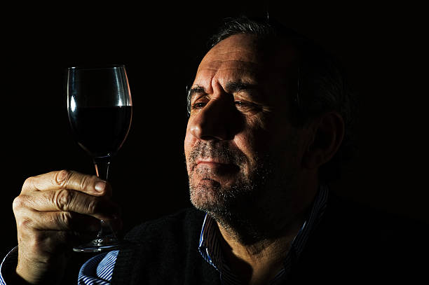 man-holding-wine-glass-thoughtfully
