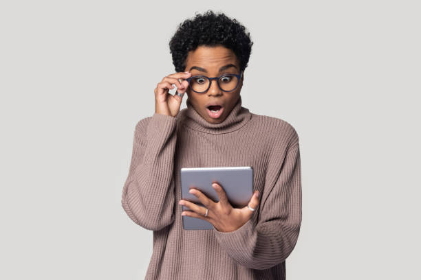 woman-with-glasses-looking-shocked-at-tablet